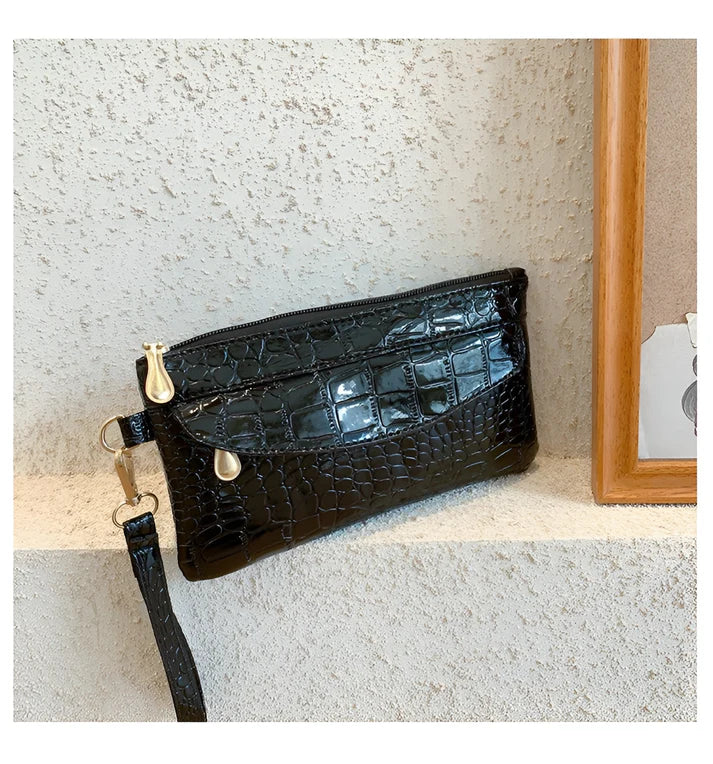 Model holding Bodhi Bag – minimalist PU wallet clutch with zipper closure and sequined sparkle finish by Santori The Label