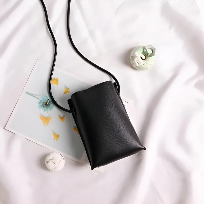 Model wearing Felly Bag – minimalist PU leather shoulder bag with hasp closure and smooth finish, by Santori The Label