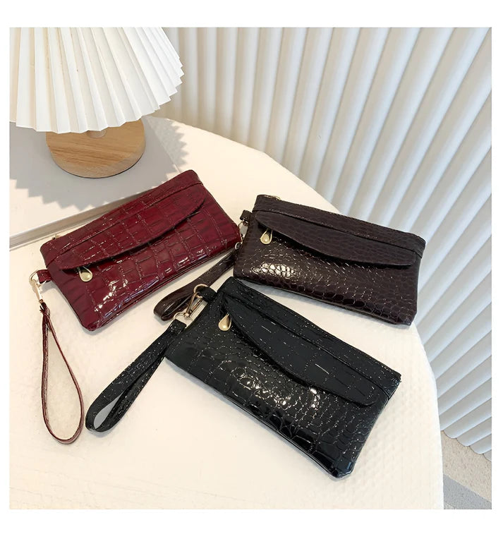 Model holding Bodhi Bag – minimalist PU wallet clutch with zipper closure and sequined sparkle finish by Santori The Label