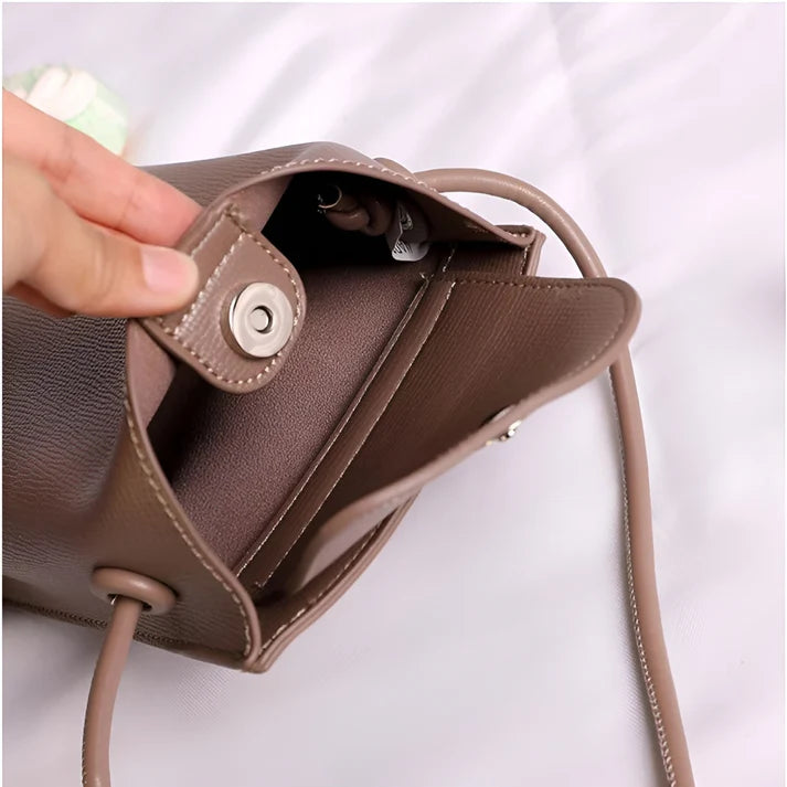 Model wearing Felly Bag – minimalist PU leather shoulder bag with hasp closure and smooth finish, by Santori The Label