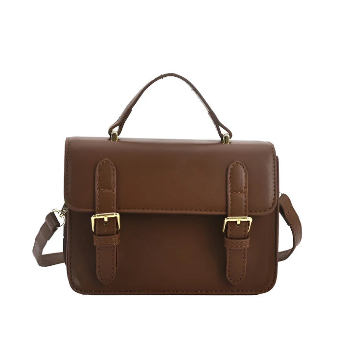 Model holding Ishna Bag – minimalist PU leather clutch with flap pocket and hasp closure in compact structured silhouette by Santori The Label
