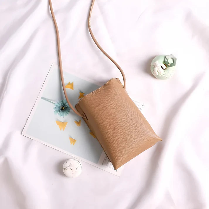 Model wearing Felly Bag – minimalist PU leather shoulder bag with hasp closure and smooth finish, by Santori The Label
