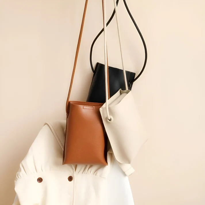 Model wearing Felly Bag – minimalist PU leather shoulder bag with hasp closure and smooth finish, by Santori The Label