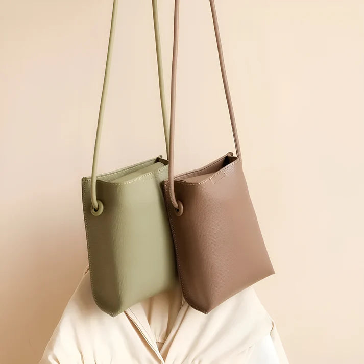 Model wearing Felly Bag – minimalist PU leather shoulder bag with hasp closure and smooth finish, by Santori The Label