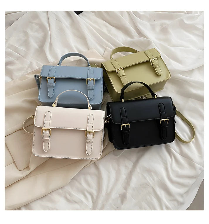 Model holding Ishna Bag – minimalist PU leather clutch with flap pocket and hasp closure in compact structured silhouette by Santori The Label