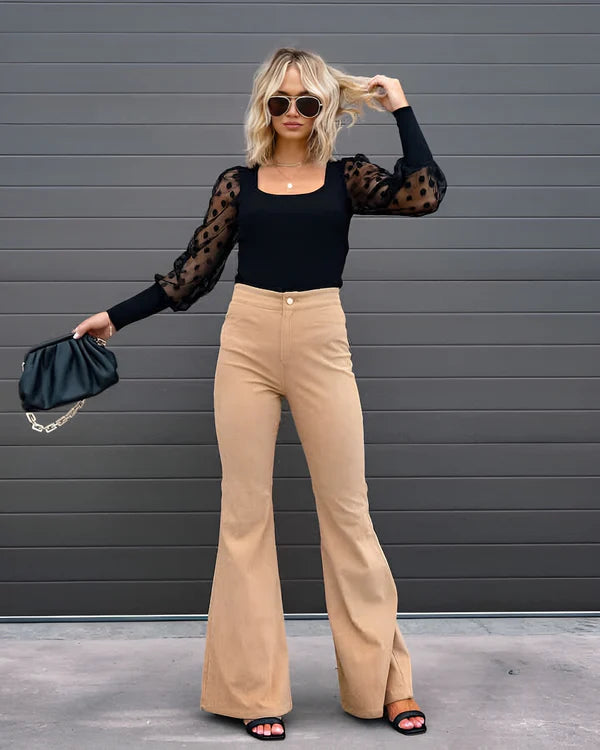 Model wearing Sheena Pants – full-length flare trousers with slim fit and mid-rise cut, styled for winter wear by Santori The Label