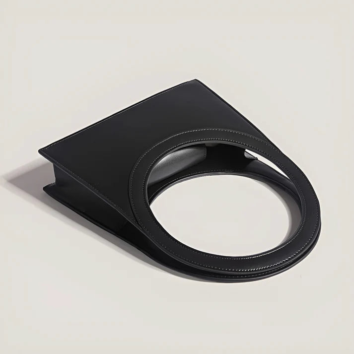 Model holding Miriah Bag – compact PU leather handbag with ring handle, high-end finish, and minimalist motorcycle-inspired design by Santori The Label