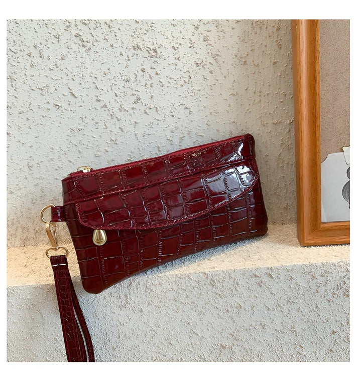 Model holding Bodhi Bag – minimalist PU wallet clutch with zipper closure and sequined sparkle finish by Santori The Label