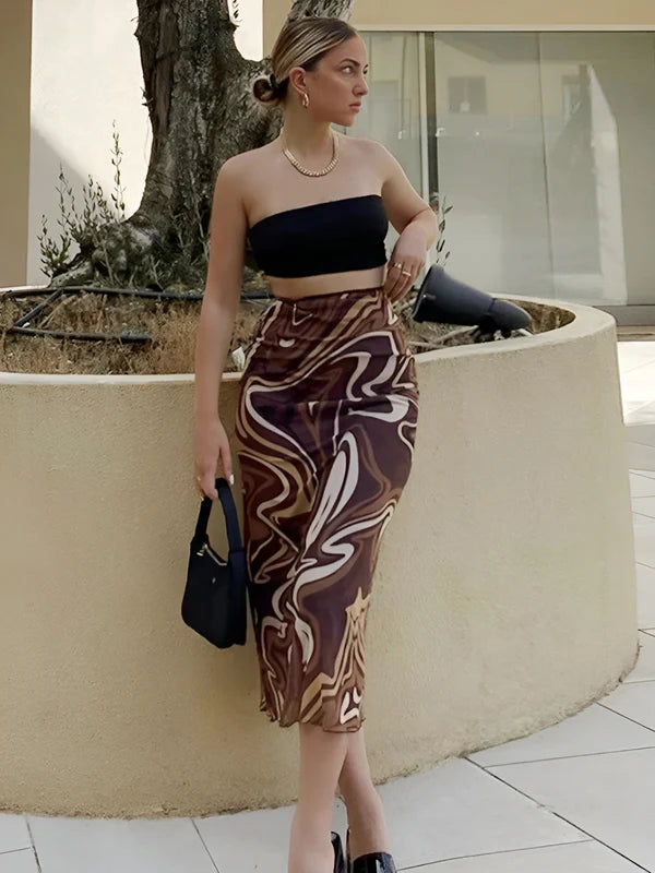 Model wearing Jamaica Midi Skirt in abstract swirl print, styled with casual summer fashion top – Santori The Label
