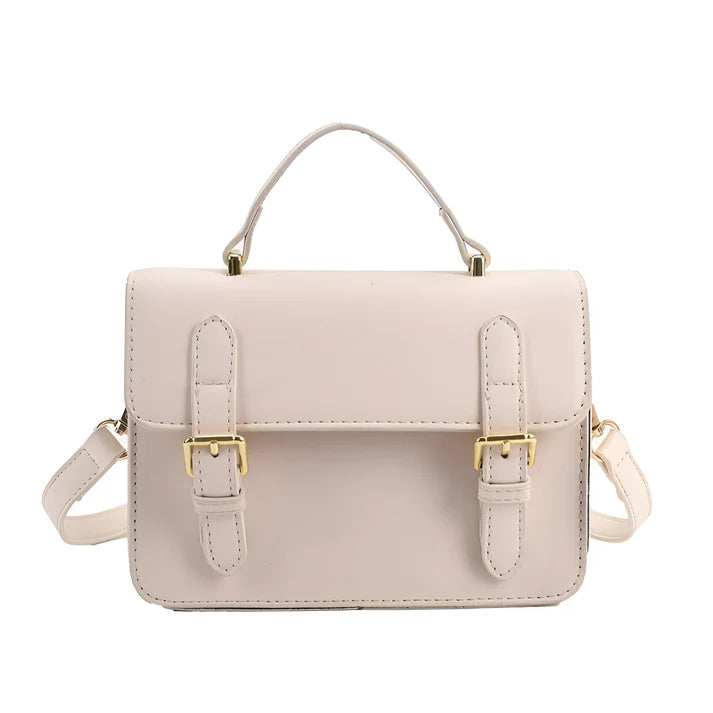 Model holding Ishna Bag – minimalist PU leather clutch with flap pocket and hasp closure in compact structured silhouette by Santori The Label